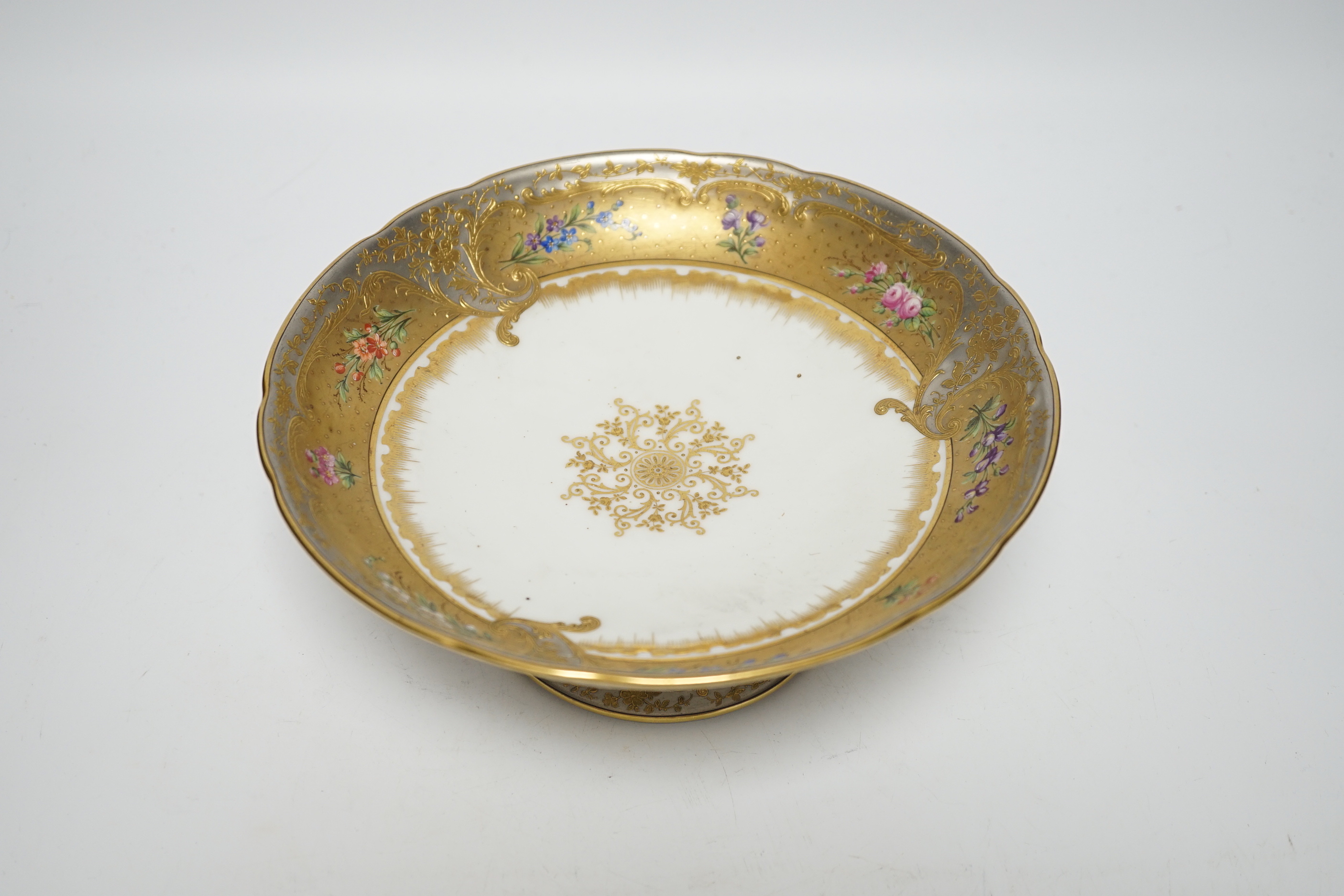 A late 19th Ernst Wahliss Vienna eighteen piece porcelain floral dessert service and a plate carrier, largest pieces 22cm in diameter